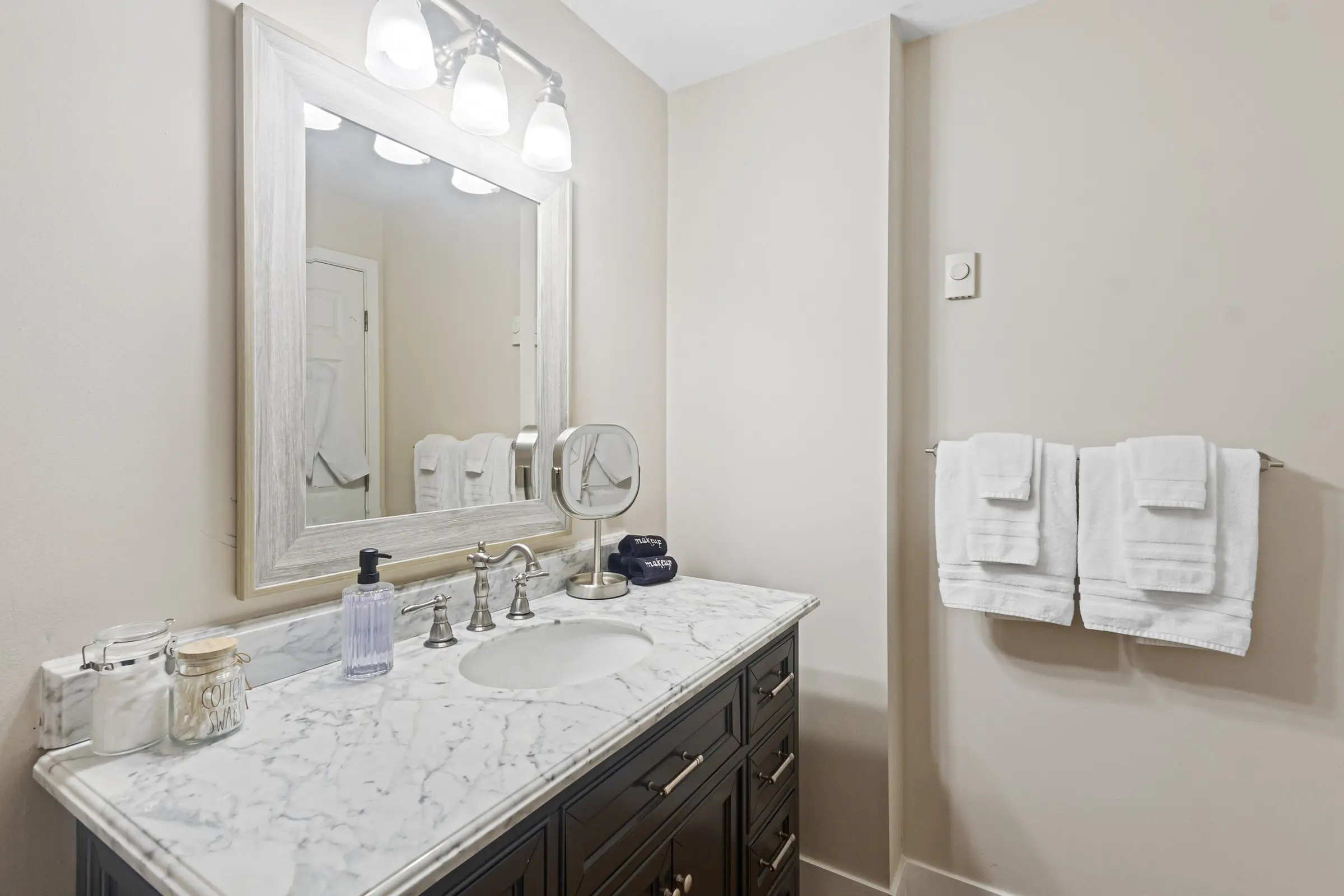 Bathroom with marble-top vanity and stocked toiletries at Magnolia House in Bend, Oregon