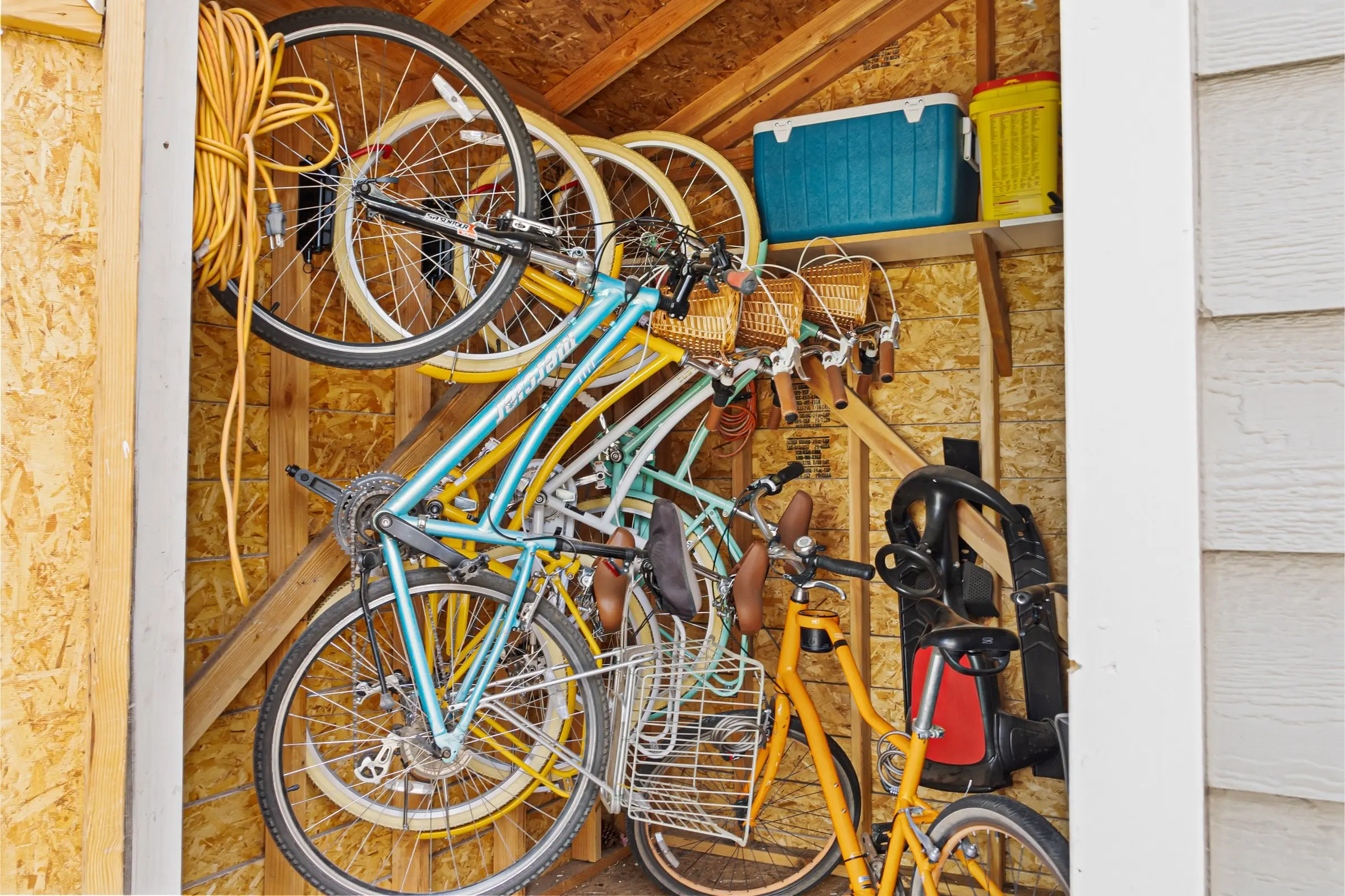 Cruiser bikes hanging in the bike shed at Magnolia House, free for guests to ride around Bend