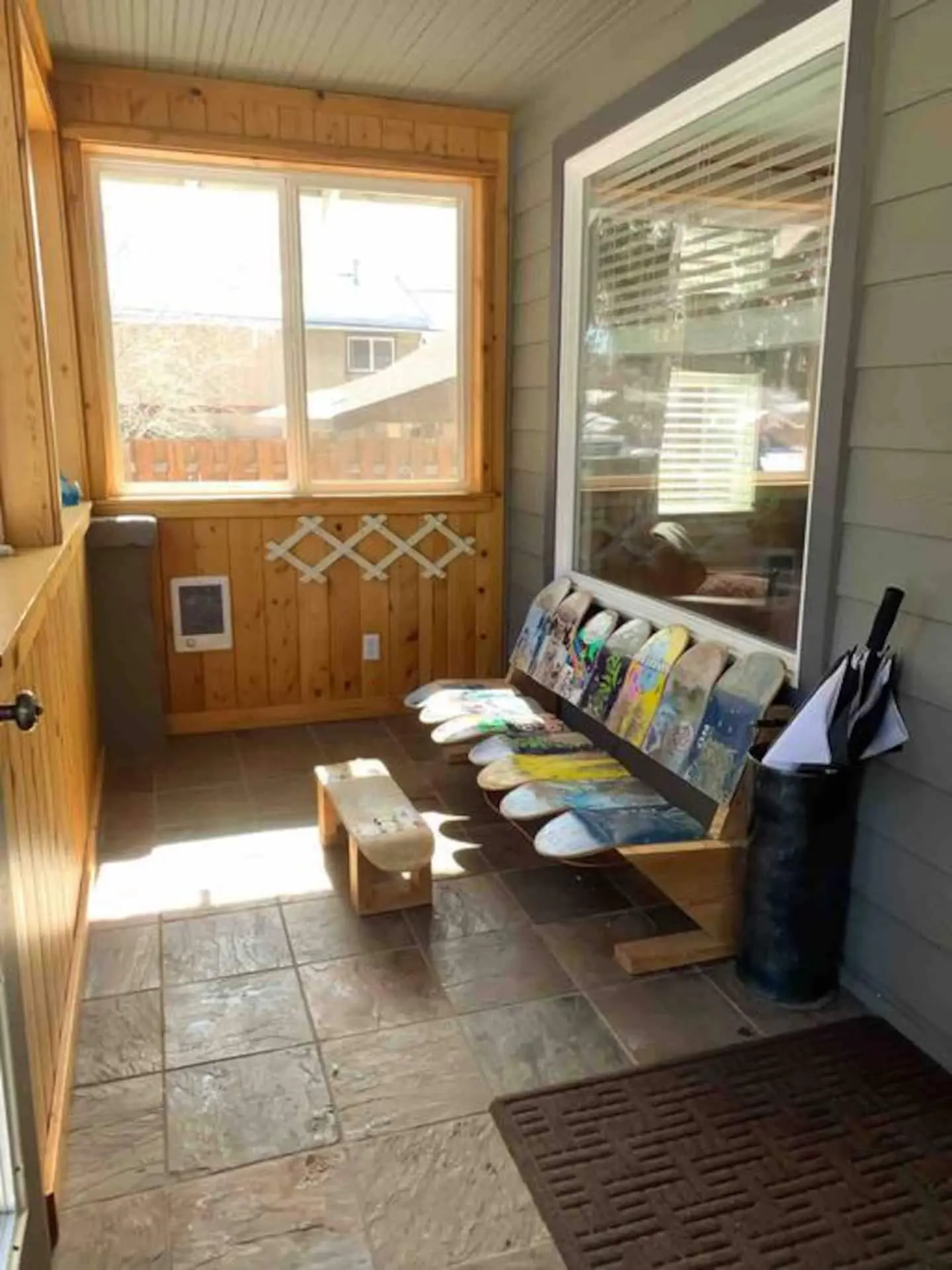Entry bench and gear storage area with boot-drying room at Magnolia House in Bend