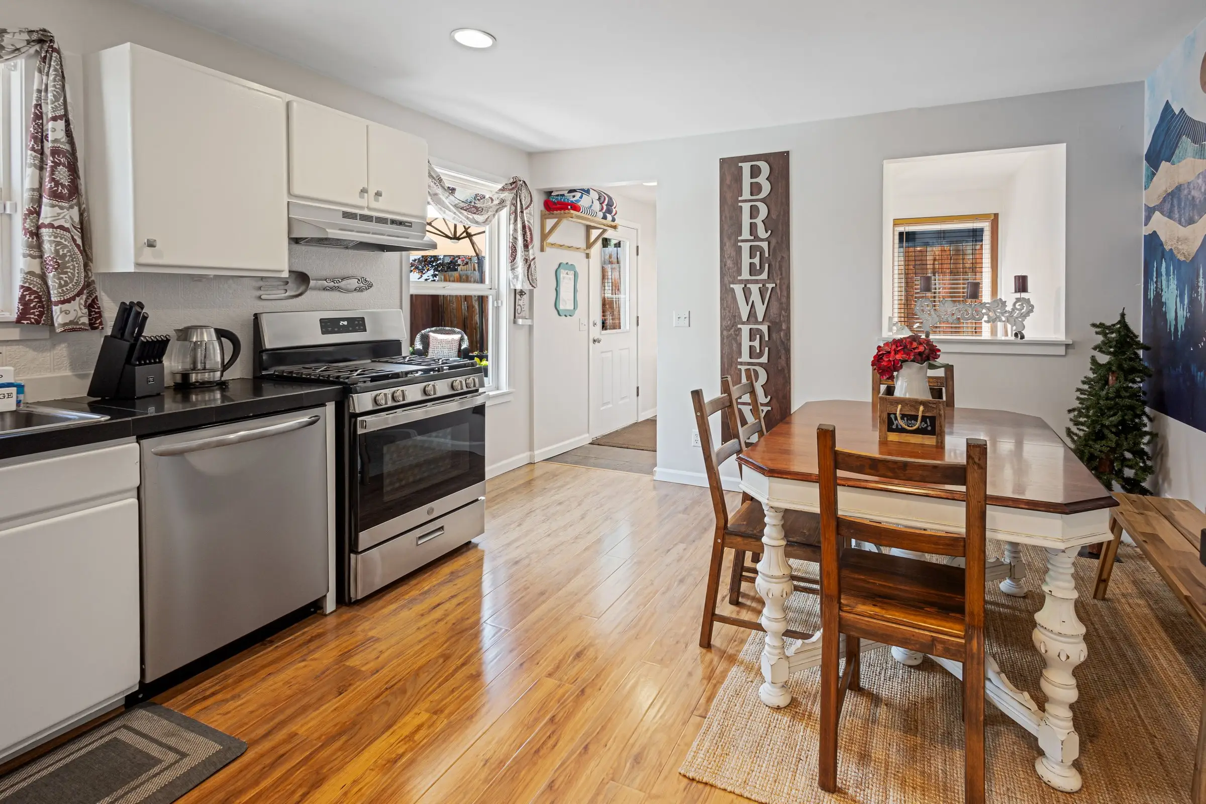 Open kitchen and dining area with hardwood floors at Magnolia House in Bend, Oregon