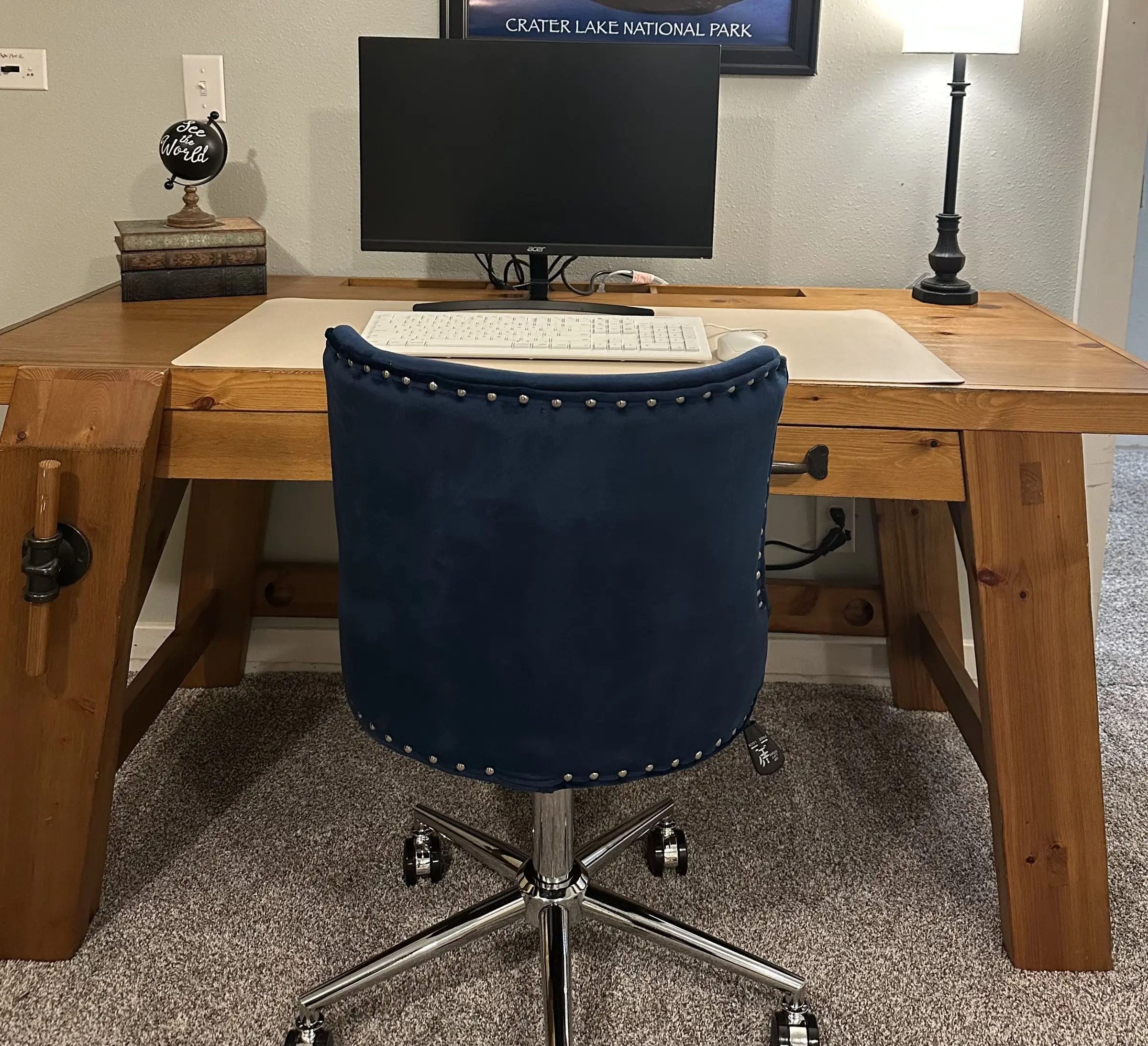Dedicated workspace with desk, external monitor, and office chair at Magnolia House — 1-gig Wi-Fi
