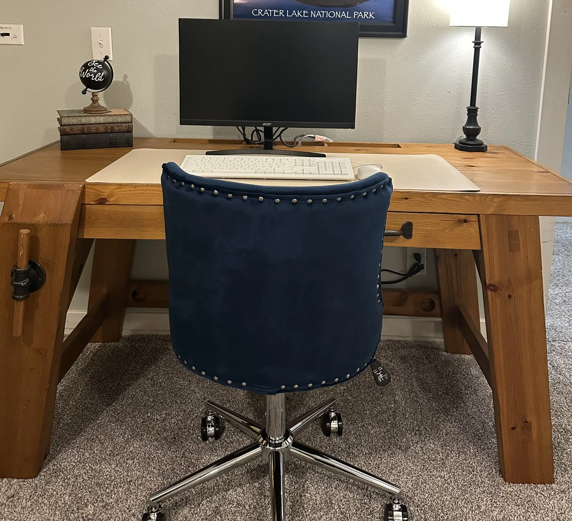 Dedicated workspace with desk, external monitor, and office chair at Magnolia House — 1-gig Wi-Fi